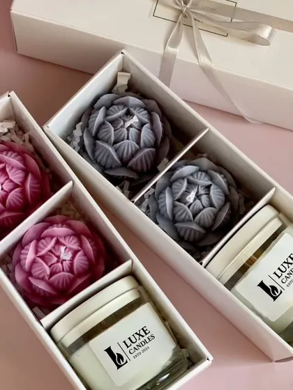 A beautiful Diwali gift hamper containing two large lotus candles and a scented jar candle, elegantly boxed.