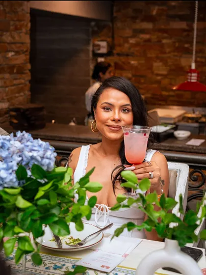 A guest raises her glass, surrounded by flowers. Our special pasta event brought recipes and stories lost to time back to life, creating an afternoon of delicious memories.