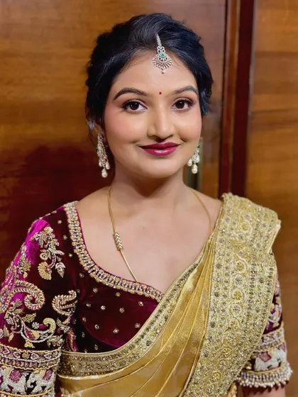Dr. Nayana looking elegant for a family event. This look features a soft glam eye and a deep berry lip, paired with a classic updo.