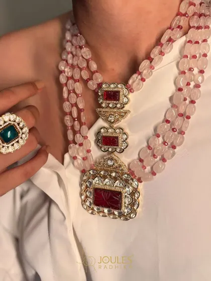 Beauty in every bead. This magnificent necklace features multiple strands of pink beads culminating in a large, carved ruby and polki pendant.