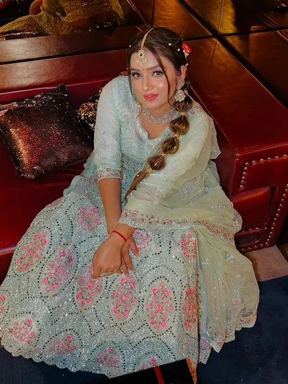 A high-angle shot that gives a great view of the lehenga's intricate sequin and embroidery work. The makeup and hair are styled to perfection, completing this stunning party ensemble.