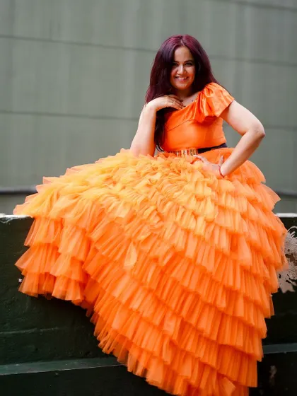 Another angle of the orange ruffle gown. The bright color is perfect for making a statement and looks amazing in photos.