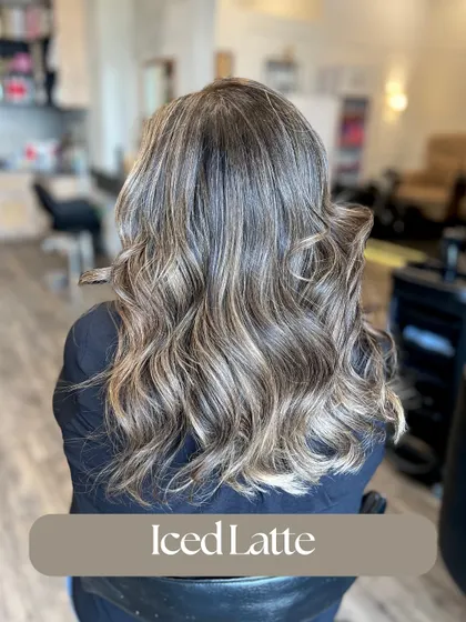 This Iced Latte look is a cool-toned balayage that blends ashy blonde pieces into a darker base. It's a modern and chic way to go lighter.