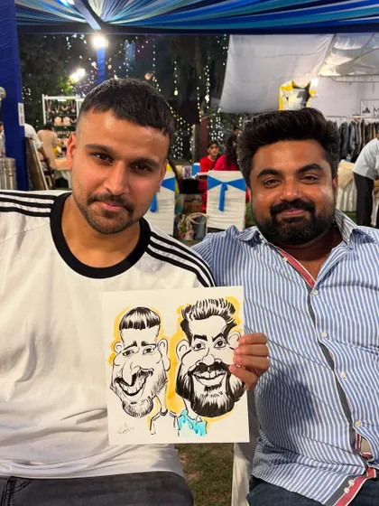 Two friends enjoying their caricature, a fun memory from a day out.