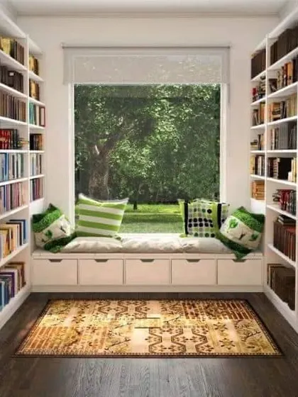 Another take on a library nook, this design features floor-to-ceiling bookshelves flanking a window seat with storage. It's a book lover's dream.