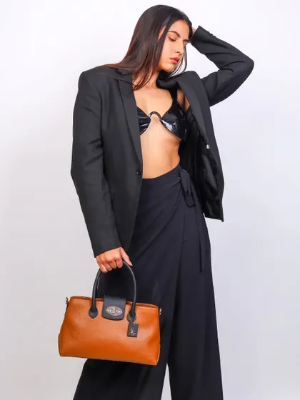 A three-quarter shot focusing on the Yuvastree handbag. The model's pose feels natural and confident, giving the product a real-world context.