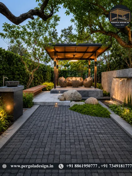 An evening view of a garden gazebo, where integrated lighting transforms the space into a magical retreat. Nestled among trees and alongside a water feature, it’s the perfect spot for unwinding after a long day.