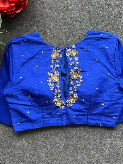 A full view of the back of the royal blue handwork blouse, showcasing the detailed embroidery.