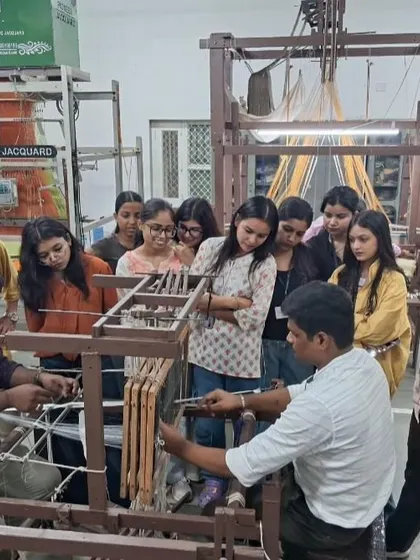 Students observe a demonstration of a Handloom Electronic Jacquard machine, learning about the technology that powers complex textile designs.