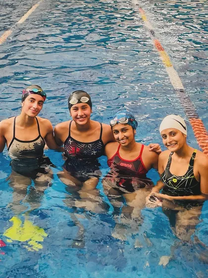 A happy moment in the pool with Rhea Gupta (far right) and her teammates. Rhea's journey from a young swimmer to a student at a top US university is an inspiration to us all.