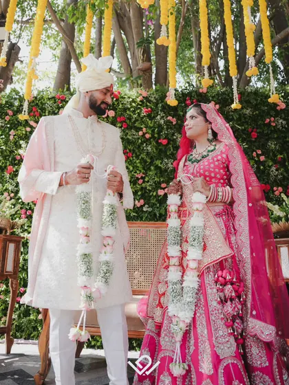 A couple exchanges garlands during their Varmala ceremony, a key ritual in North Indian weddings.
