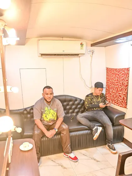A different angle of me and Rapper Big Deal chilling before our performance at the Hockey World Cup.