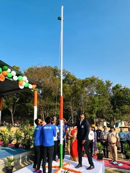 A wide shot of the flag being raised high against the clear blue sky. This symbolizes the heights we aim to reach for our country in the world of sports.