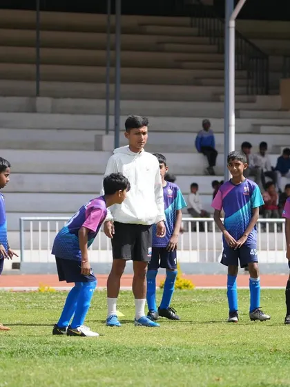 Behind the scenes in Ooty, a coach gives instructions to the team before they take the field for a friendly match.