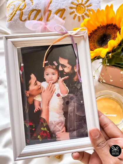 We included a precious family photo of Alia, Ranbir, and Raha in the custom hamper we designed for them.
