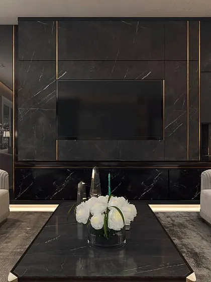 This media wall is crafted from black marble with inlaid brass details, creating a bold and luxurious focal point. The integrated fireplace and symmetrical sofa arrangement result in a balanced and powerful design statement.