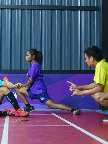Team talk and stretching on the court. Our facilities are not just for playing; they're for communities to train, strategize, and grow together.