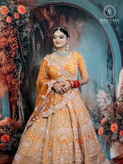 A full-length shot capturing the bride's complete look. The way the dupatta is draped and the lehenga flows creates a look of effortless grace and grandeur.