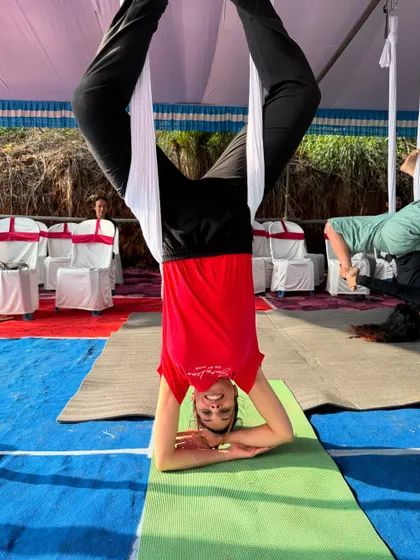 A student confidently holding her inversion. It's so rewarding to see people conquer their fears and find their strength in the air.