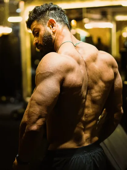 Another perspective on back development, highlighting the thickness of the traps and lats.