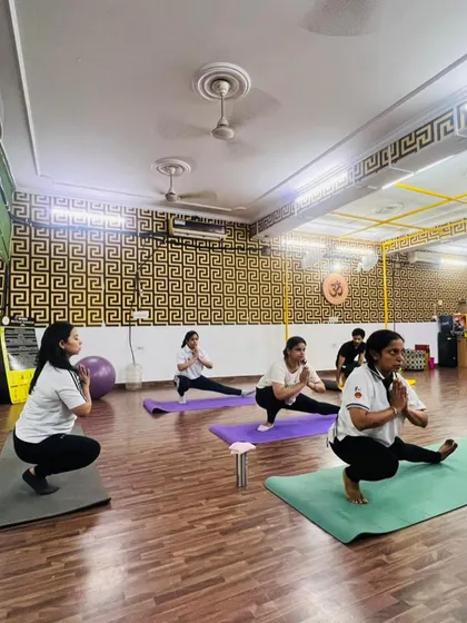 In sync and feeling strong. This is a glimpse of our group yoga class, where we flow together. The energy of the group keeps everyone motivated.