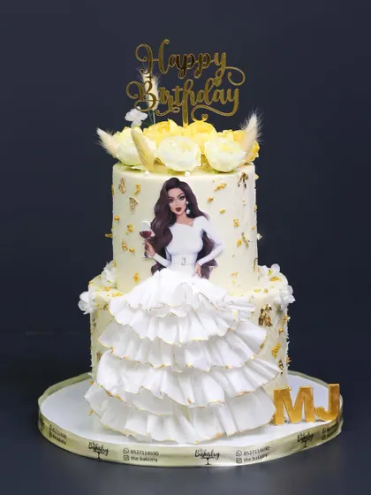 A full view of the elegant white ruffled dress cake, initialed "MJ" for a personalized touch.