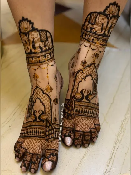 Your feet deserve beautiful mehndi too. This design features elegant elephants and peacocks in an architectural frame, creating a stunning payal or anklet effect that is perfect for any celebration.