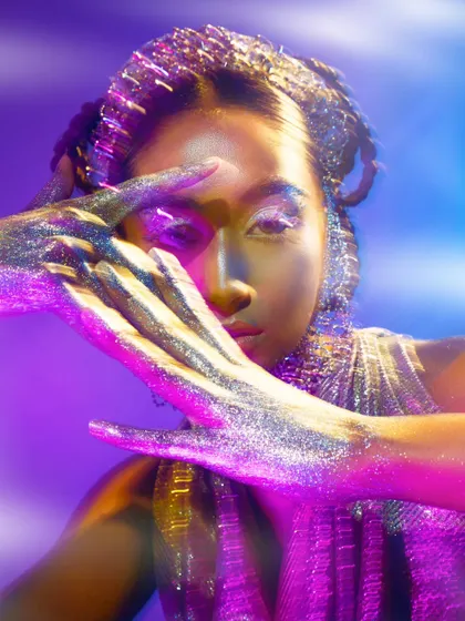 A multi-exposure effect combined with colored lighting creates a surreal and captivating beauty portrait.
