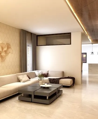 Another view of the warm-toned living room render, showing the full length of the space and the elegant floral metal art on the wall.