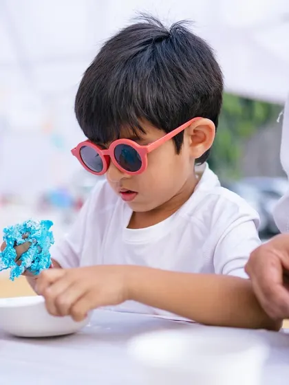 This cool little guy is completely focused on his creative project.