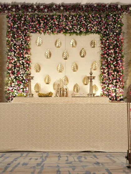 The full view of the stage, showcasing the symmetry and balance of the design. The traditional brass lamps on stage add an authentic South Indian touch to the elegant setup.