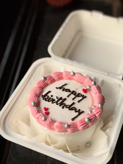 A pretty pink and white birthday bento cake. The pink piped border is decorated with silver pearls for a touch of elegance.