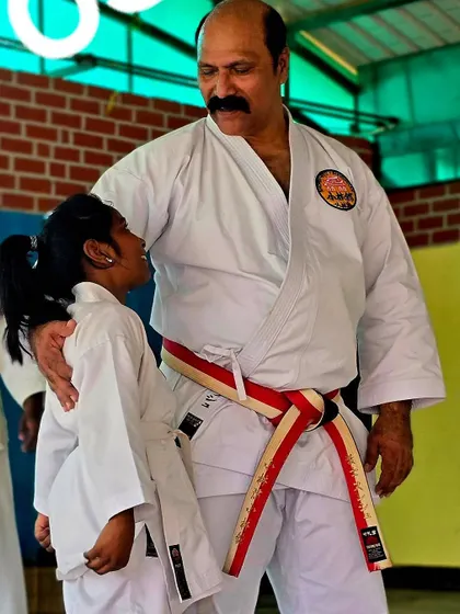A moment of encouragement with a young student at our KGF dojo. As an instructor, connecting with each student and guiding their journey is the most rewarding part of what I do.
