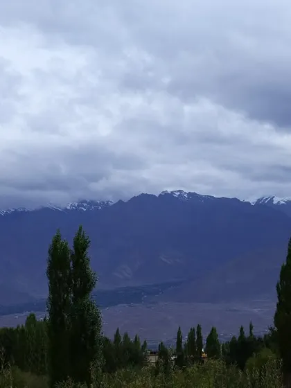 A moody, atmospheric shot of the mountains under a cloudy sky. The weather can change quickly, but the beauty of the landscape is constant.