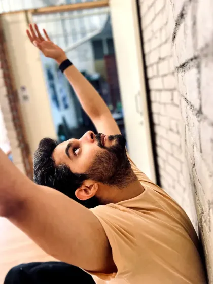 A moment of release. This simple wall stretch helps open up the chest and shoulders, an important part of a dancer's physical maintenance.