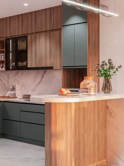 The kitchen from the 'Eleganza' series, featuring a mix of sage green and wood-finish cabinets, with a stylish breakfast bar.
