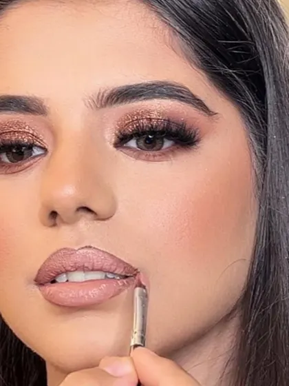 Beauty in the making. A close-up shot of me applying lipstick, one of the final and most important steps in completing a bridal look. Precision is key.