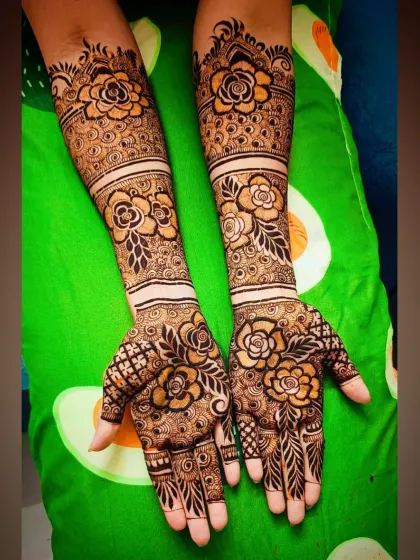 A clear, top-down view of the full-arm rose-themed mehandi.