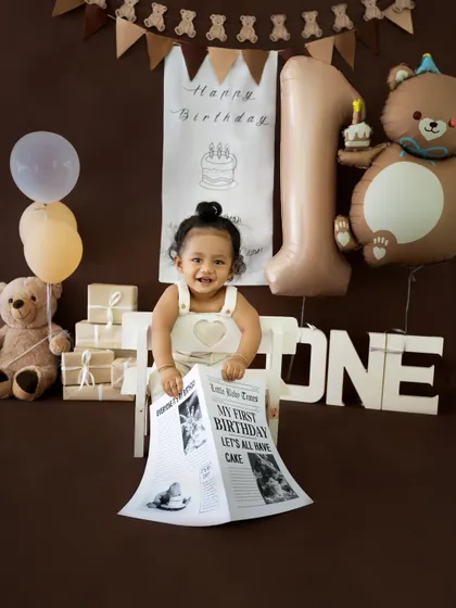 Another fun shot with the "My First Birthday" newspaper prop. This little guy is all smiles for his big day.