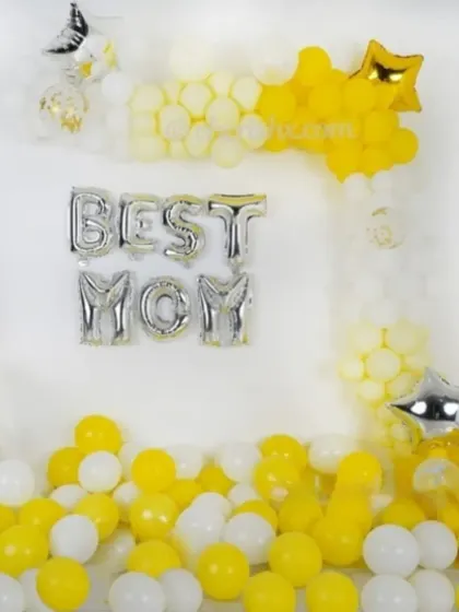 A simple and sweet 'Best Mom' decoration for Mother's Day with yellow and white balloons.