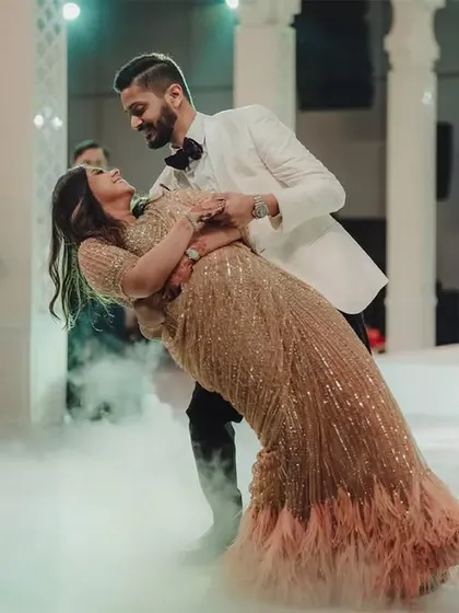 A fairytale first dance. The couple is enveloped in a low-lying fog effect on the dance floor, perfectly complementing the grand, romantic atmosphere of their engagement celebration.