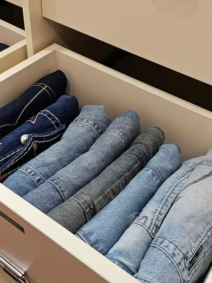Stop stacking and start file-folding. This technique for folding jeans in a drawer allows you to see every pair at a glance, making it simple to pick what you want to wear without making a mess.