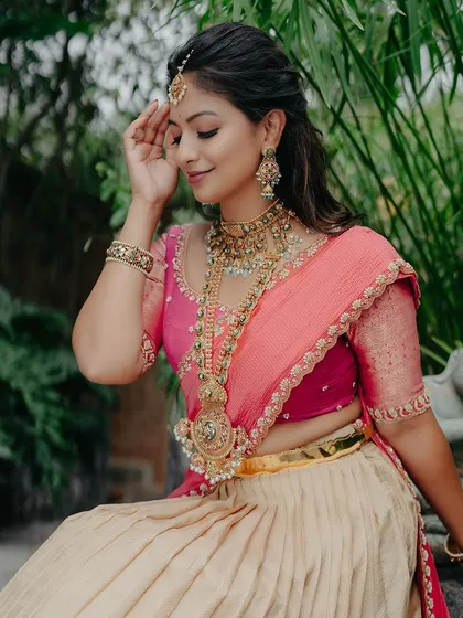 A beautiful portrait of the bride, seated, her expression serene and her attire stunning.