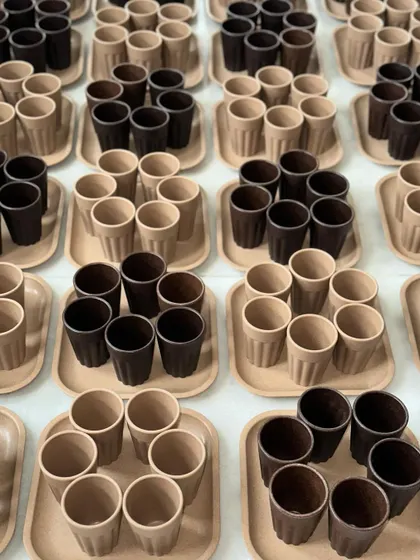 A large order of eco-friendly cup and tray sets, neatly arranged before packing, showcasing a popular sustainable corporate gift option.