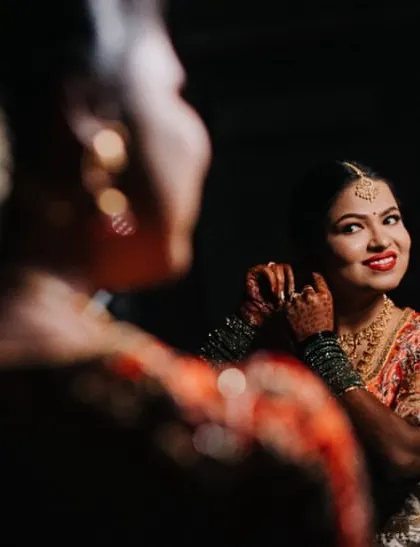 A reflection shot of the bride getting ready, a beautiful and intimate moment before the main ceremony.