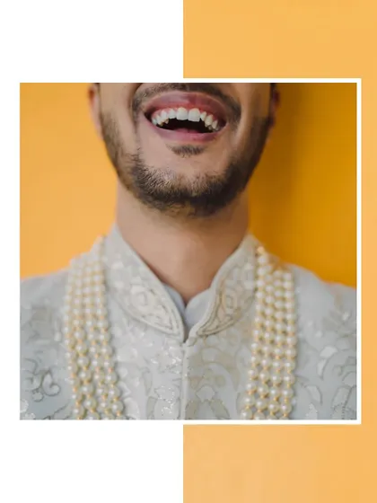 A creative close-up focusing on the groom's joyful laugh, a candid shot that captures his personality.