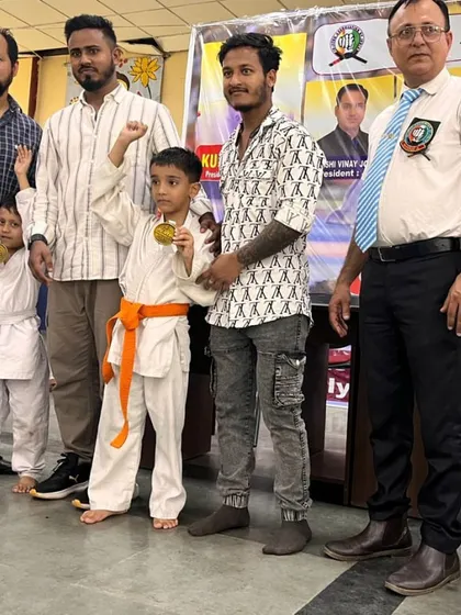 Posing with my young champions and their medals. Their success is my success. I train them to be fearless and to always aim for the top.