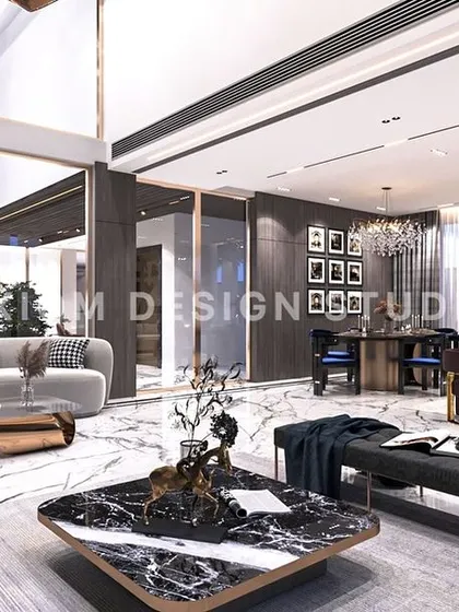 An overview of the double-height space, showing the relationship between the living area, dining zone, and the upper-level gallery.