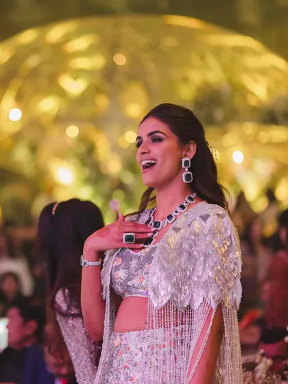 A candid shot of Manisha enjoying her sangeet. This look was designed to be as fun as it is fashionable, allowing her to celebrate in style.
