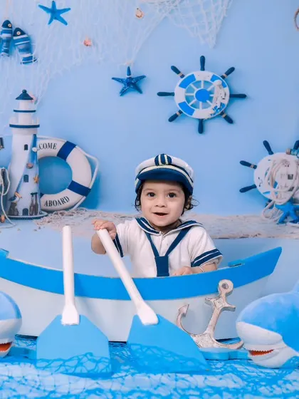 Ahoy, matey! Our sailor theme features a boat, sharks, and a complete nautical backdrop for a fun sea adventure.